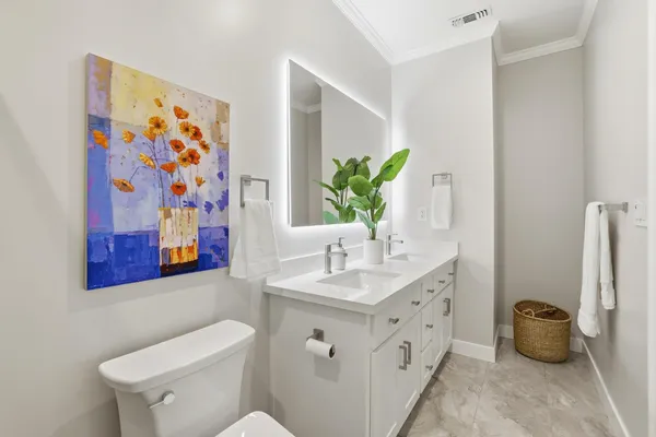 a spacious bathroom with a toilet sink and mirror