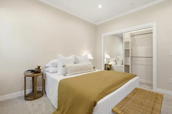 a bedroom with a bed and a couch