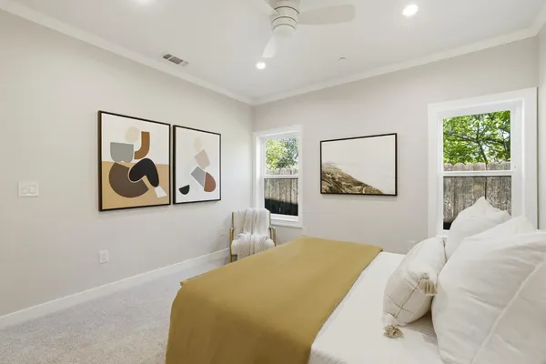a bedroom with a bed and a painting on the wall