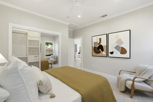 a bedroom with a bed and painting on the wall