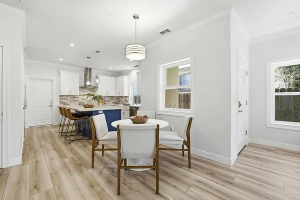 a view of a dining room with furniture window and wooden floor