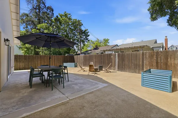 a view of a patio with a table and chairs under an umbrella