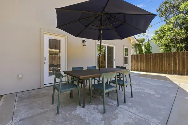 a view of a table and chairs under an umbrella