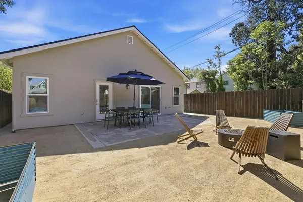 a view of a patio with a table and chairs under an umbrella
