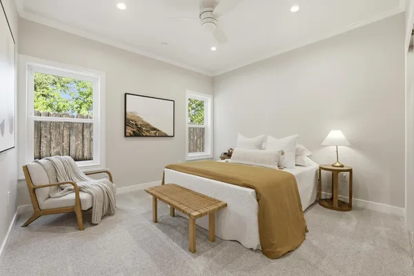 a spacious bedroom with a bed and a couch