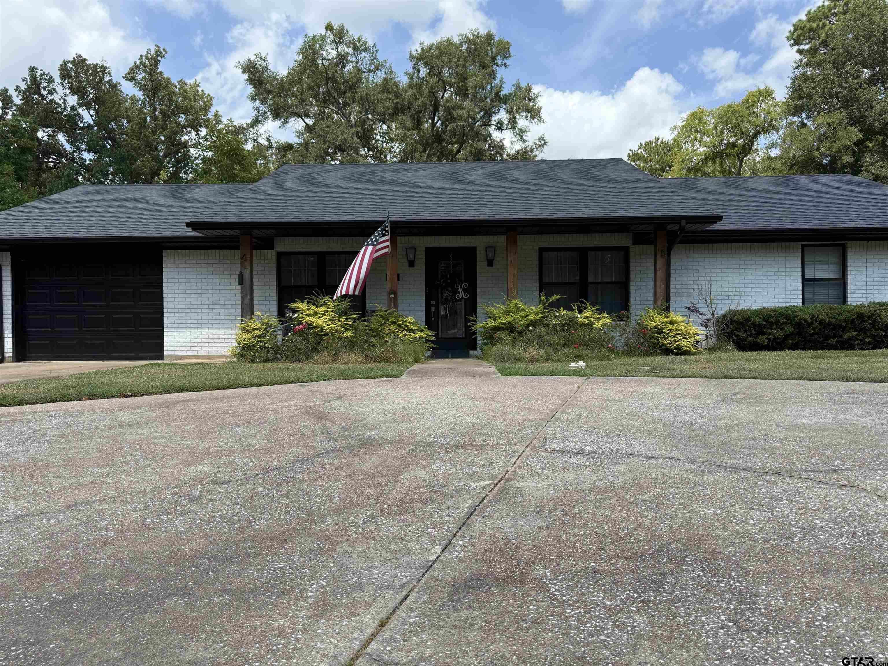 608 Pine Street Henderson, TX 75654 - Photo 1 of 46 a front view of a house with a yard and garage