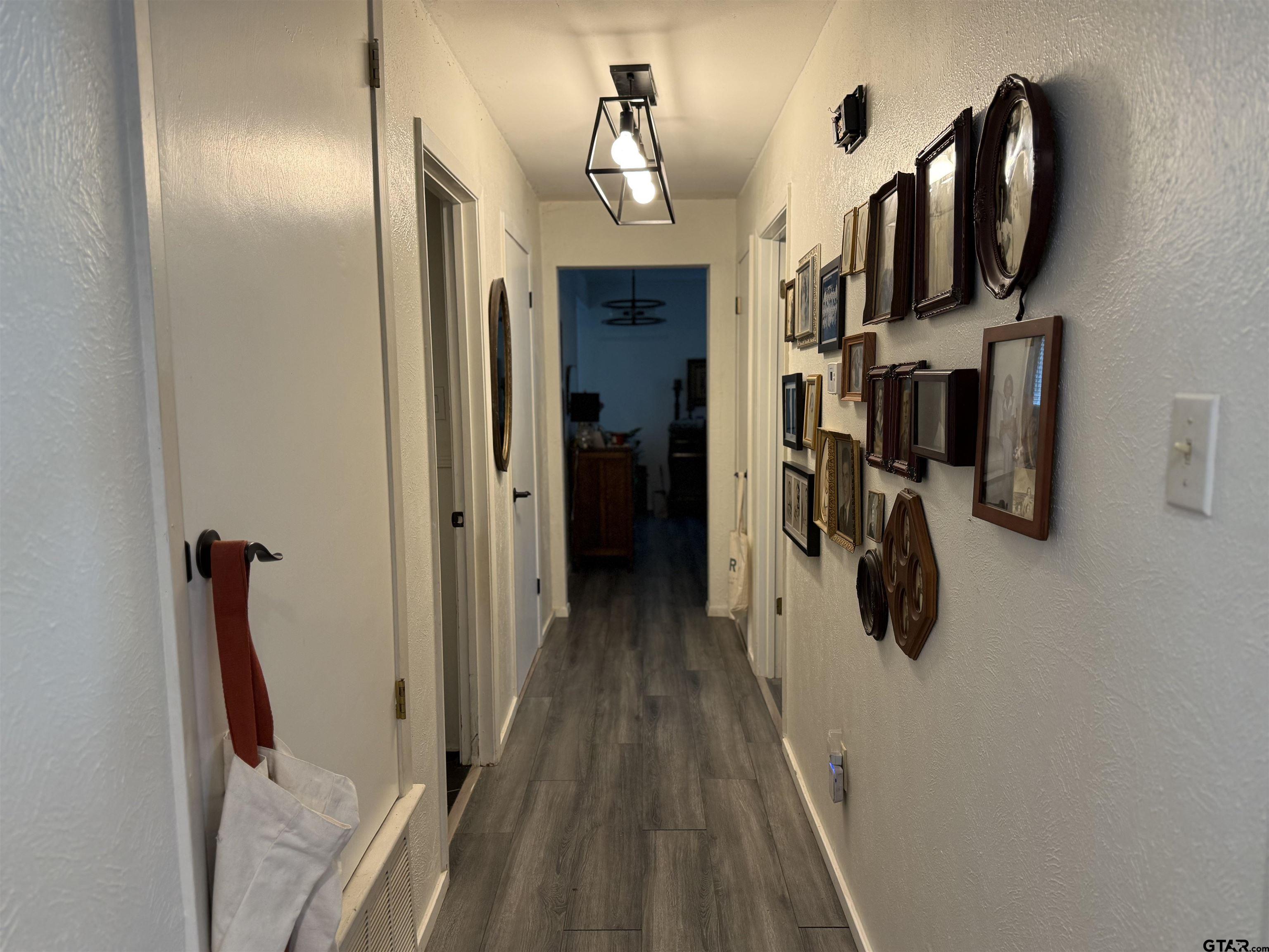 608 Pine Street Henderson, TX 75654 - Photo 11 of 46 a view of a hallway with wooden floor and staircase