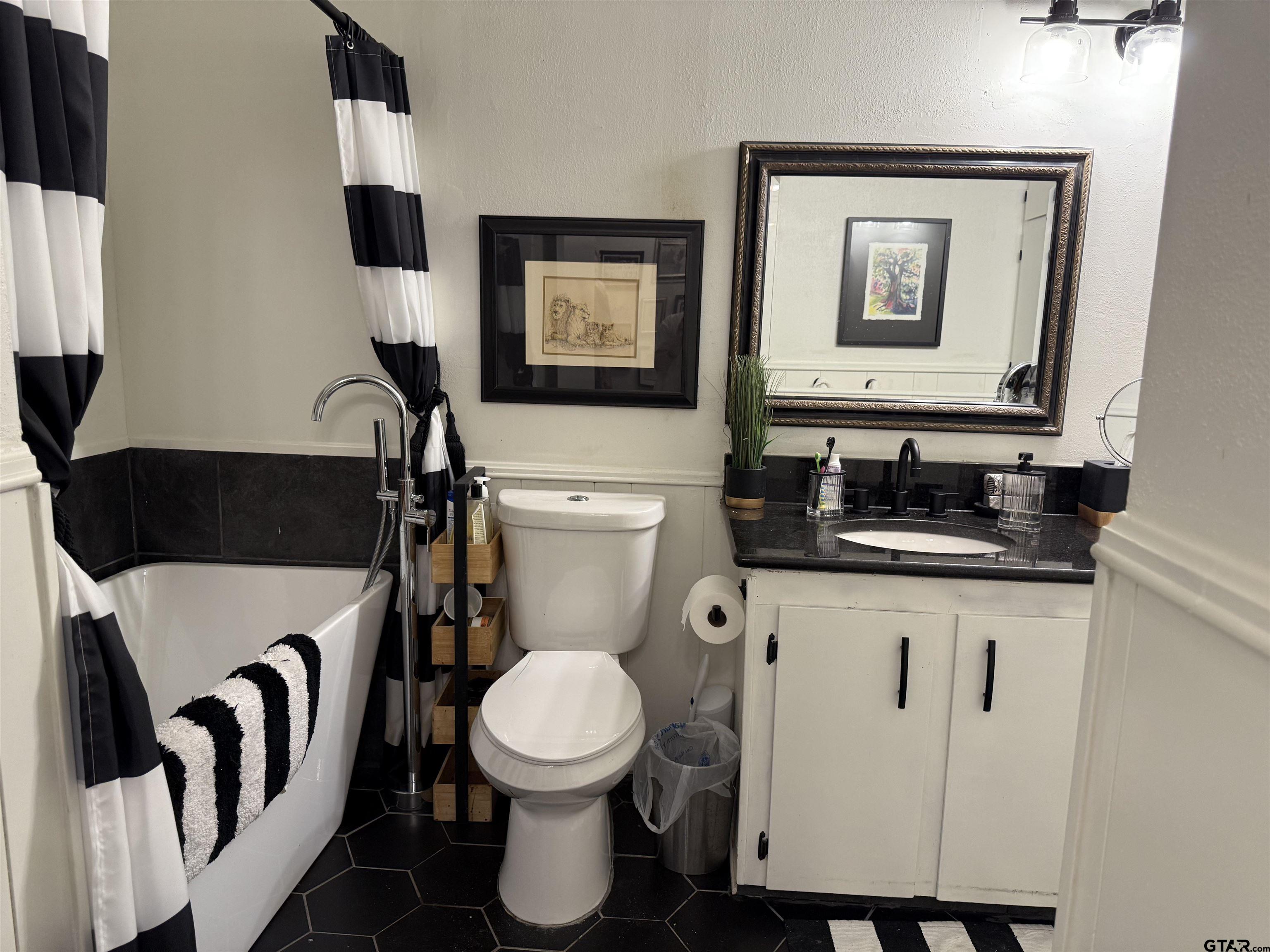 608 Pine Street Henderson, TX 75654 - Photo 13 of 46 a bathroom with a toilet sink and mirror