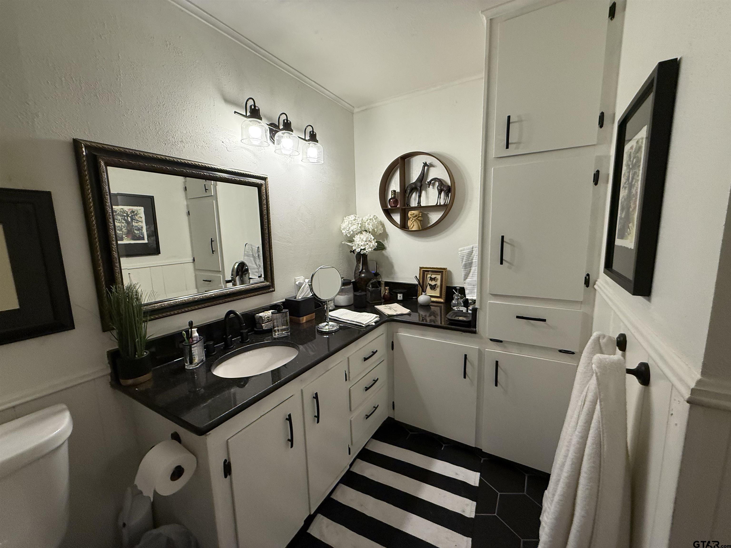 608 Pine Street Henderson, TX 75654 - Photo 15 of 46 a bathroom with a sink and a mirror