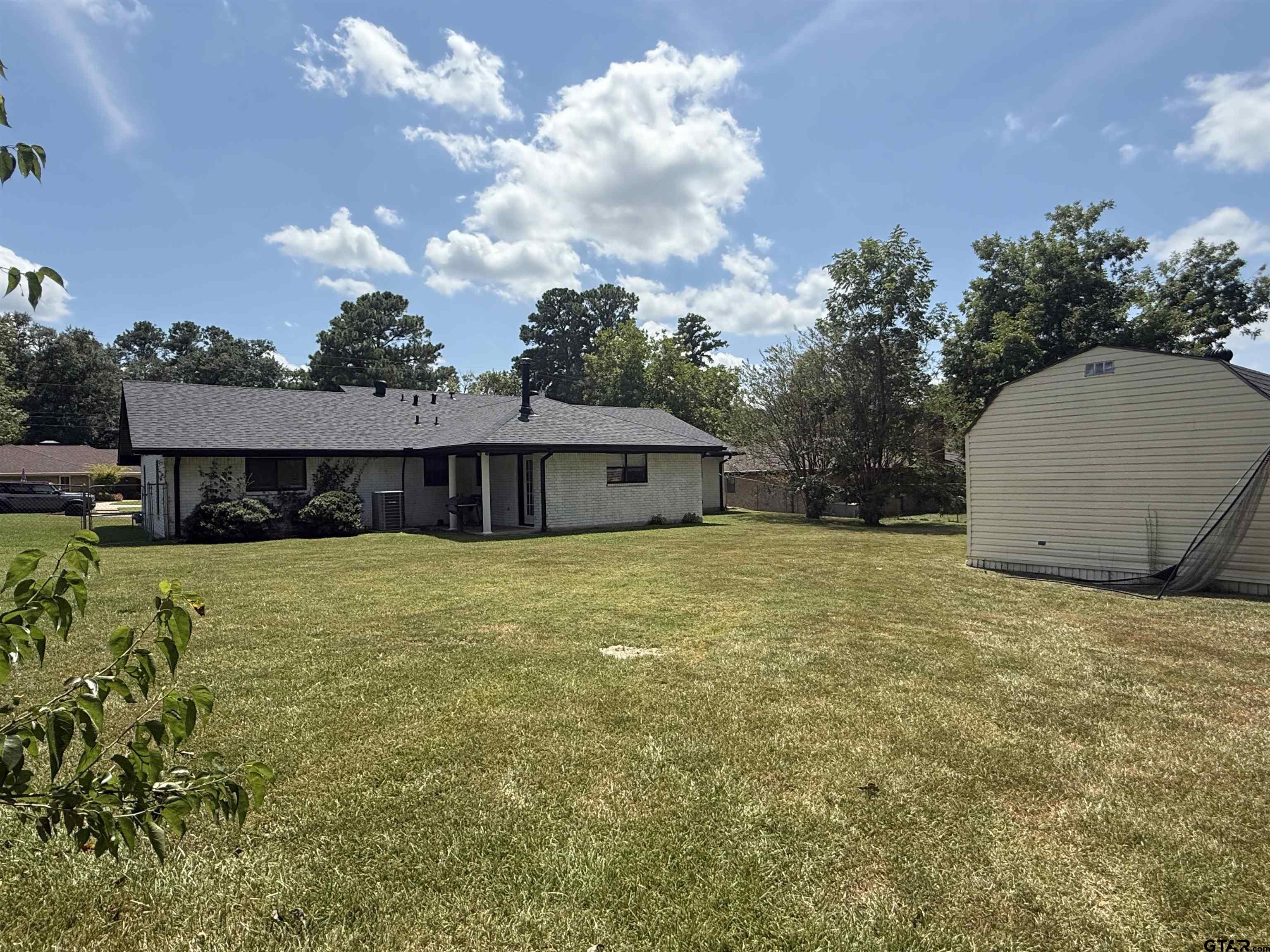 608 Pine Street Henderson, TX 75654 - Photo 18 of 46 a front view of a house with a garden and yard