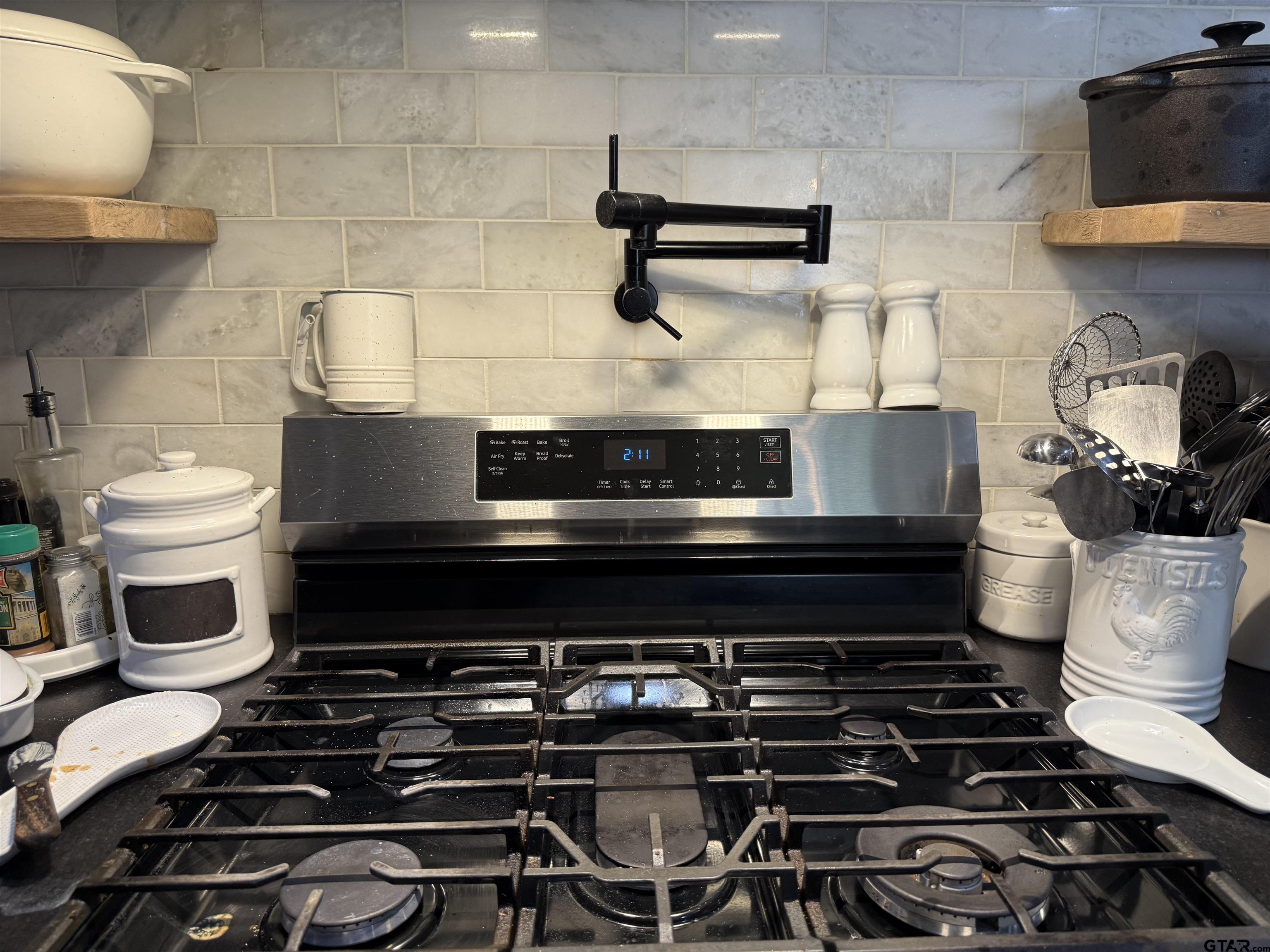 608 Pine Street Henderson, TX 75654 - Photo 29 of 46 a stove top oven sitting inside of a kitchen