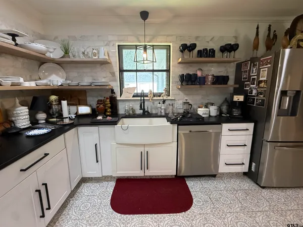 a kitchen with a stove a refrigerator and a cabinets