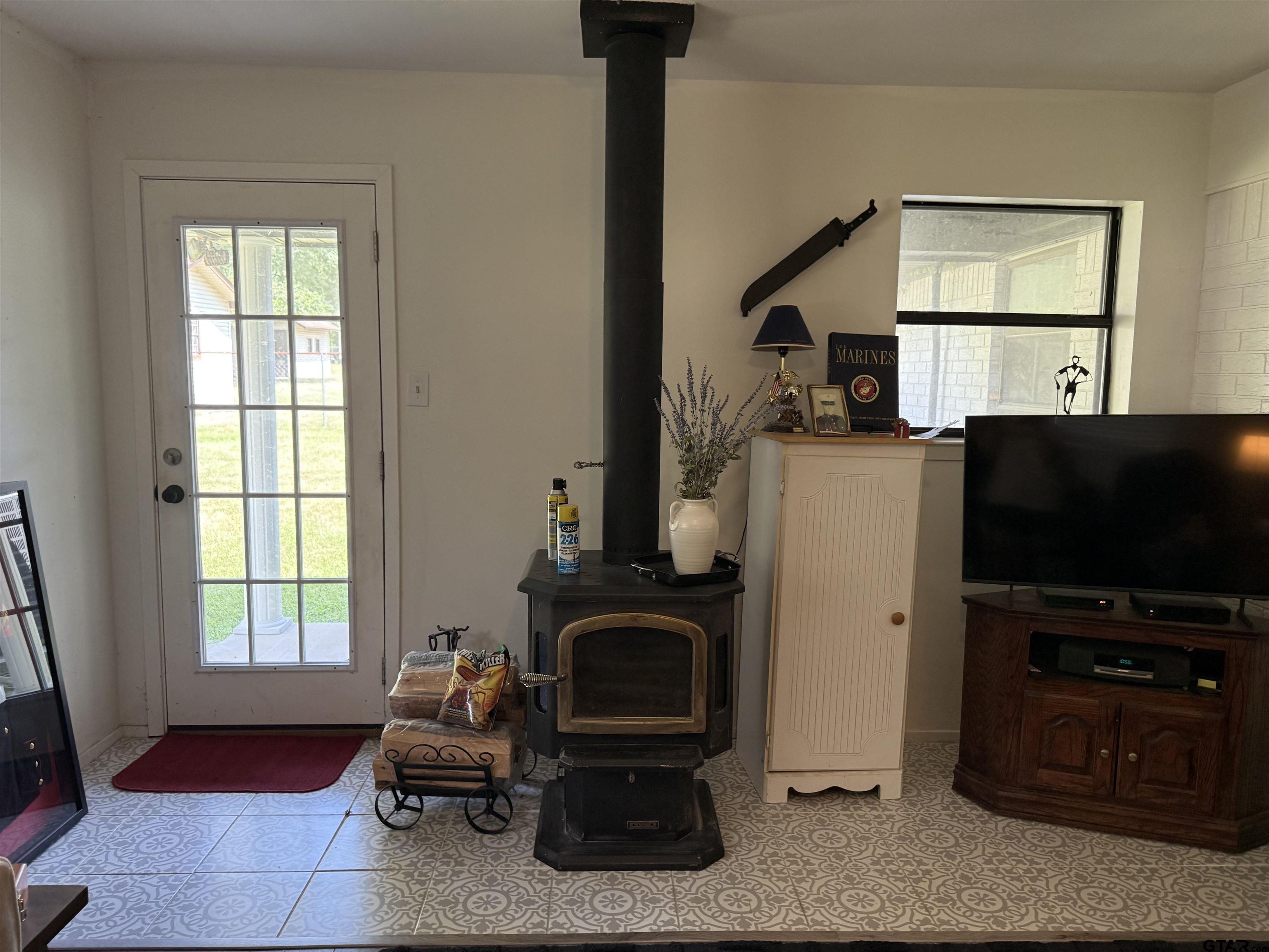 608 Pine Street Henderson, TX 75654 - Photo 35 of 46 a living room with furniture a flat screen tv and a fireplace