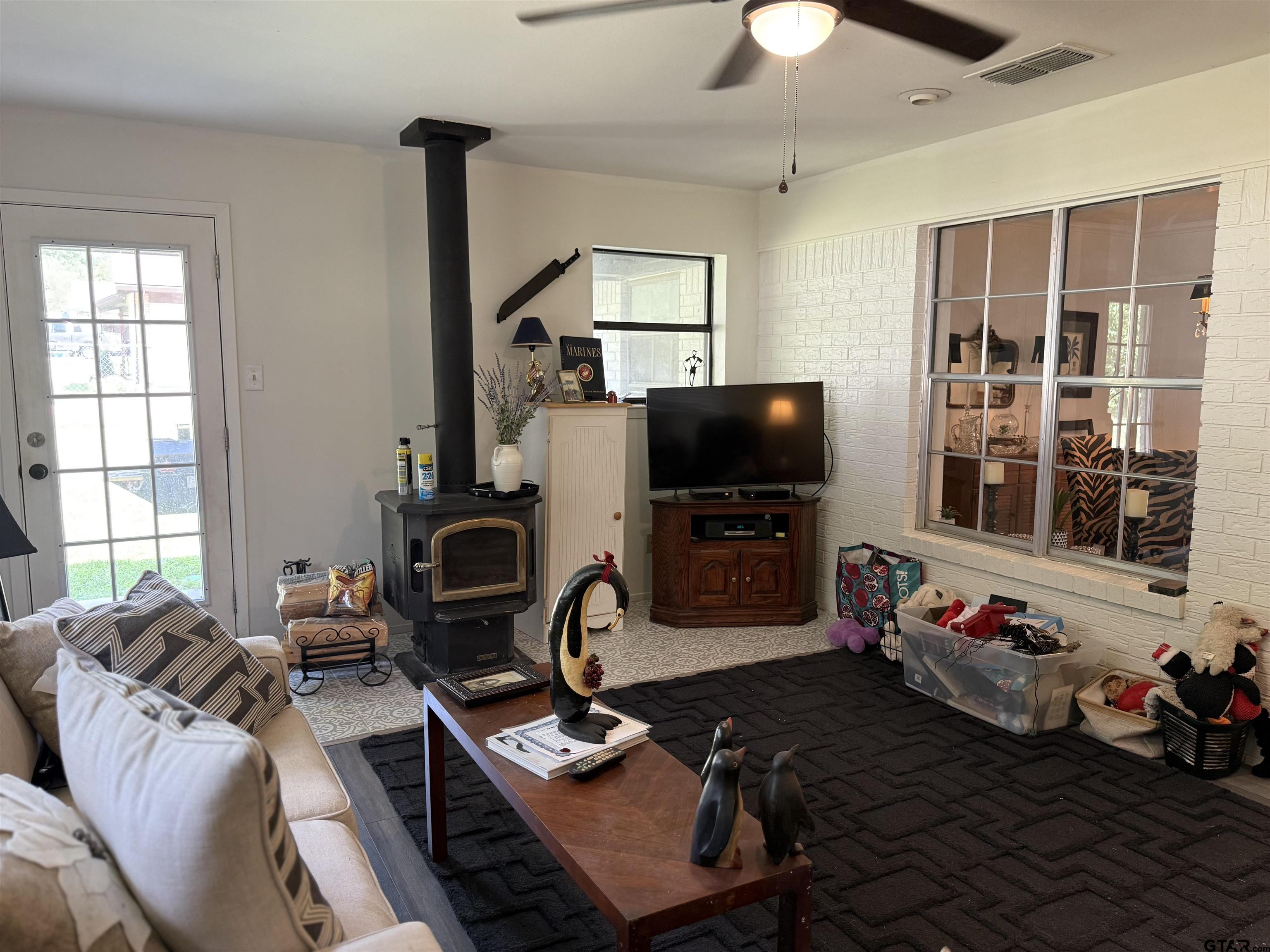 608 Pine Street Henderson, TX 75654 - Photo 36 of 46 a living room with furniture a flat screen tv and a chandelier