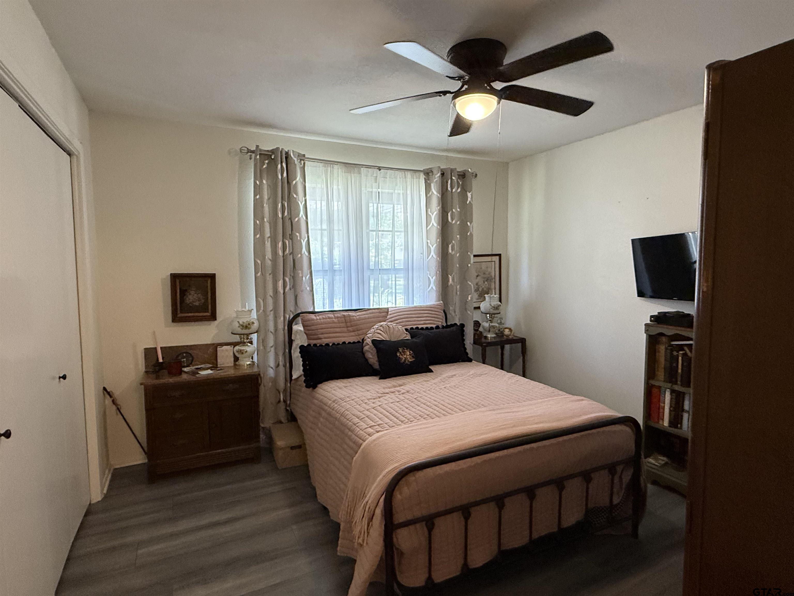 608 Pine Street Henderson, TX 75654 - Photo 37 of 46 a bedroom with a bed and a flat screen tv