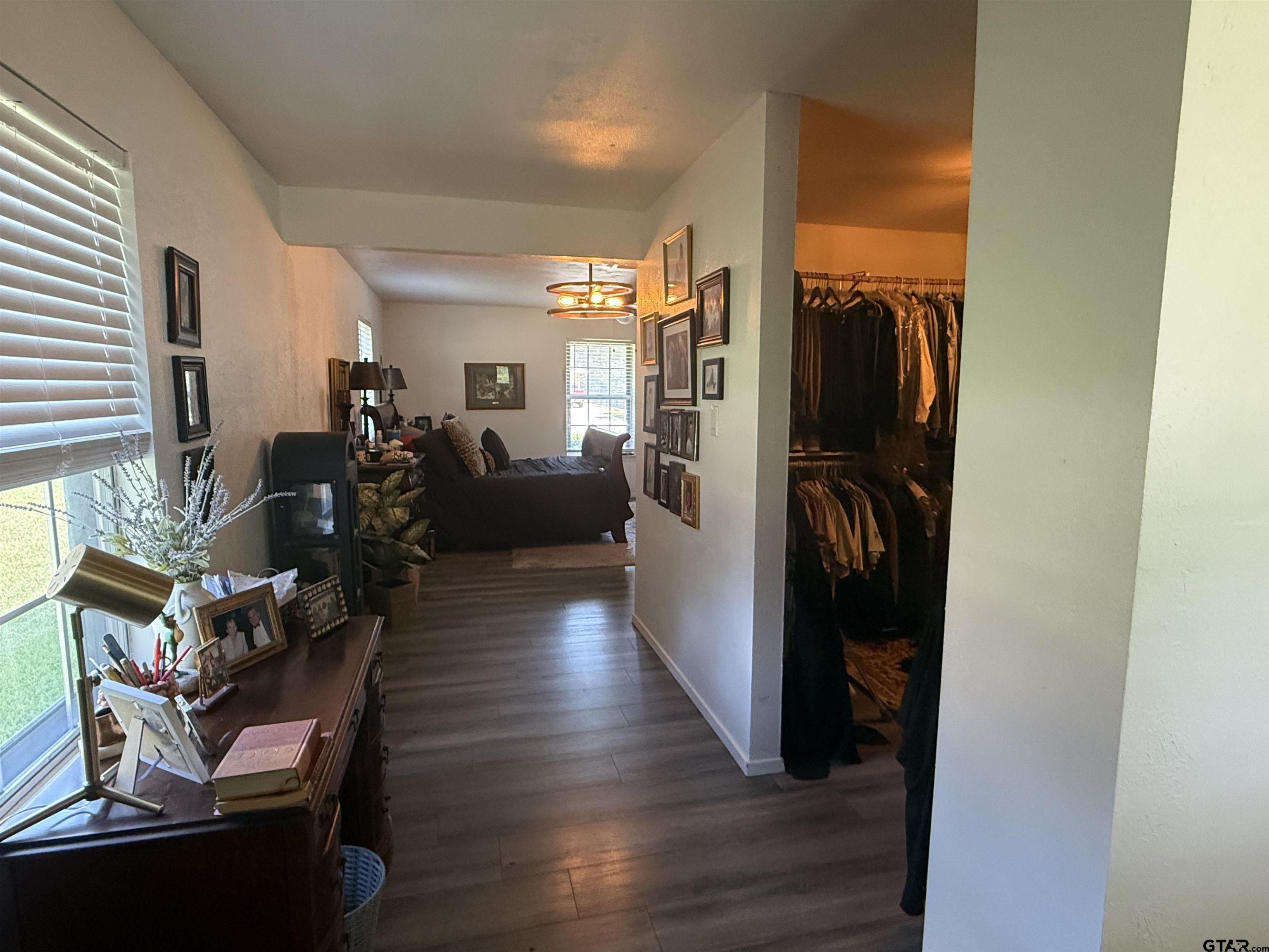 608 Pine Street Henderson, TX 75654 - Photo 40 of 46 a living room with furniture mirror and a wooden floor