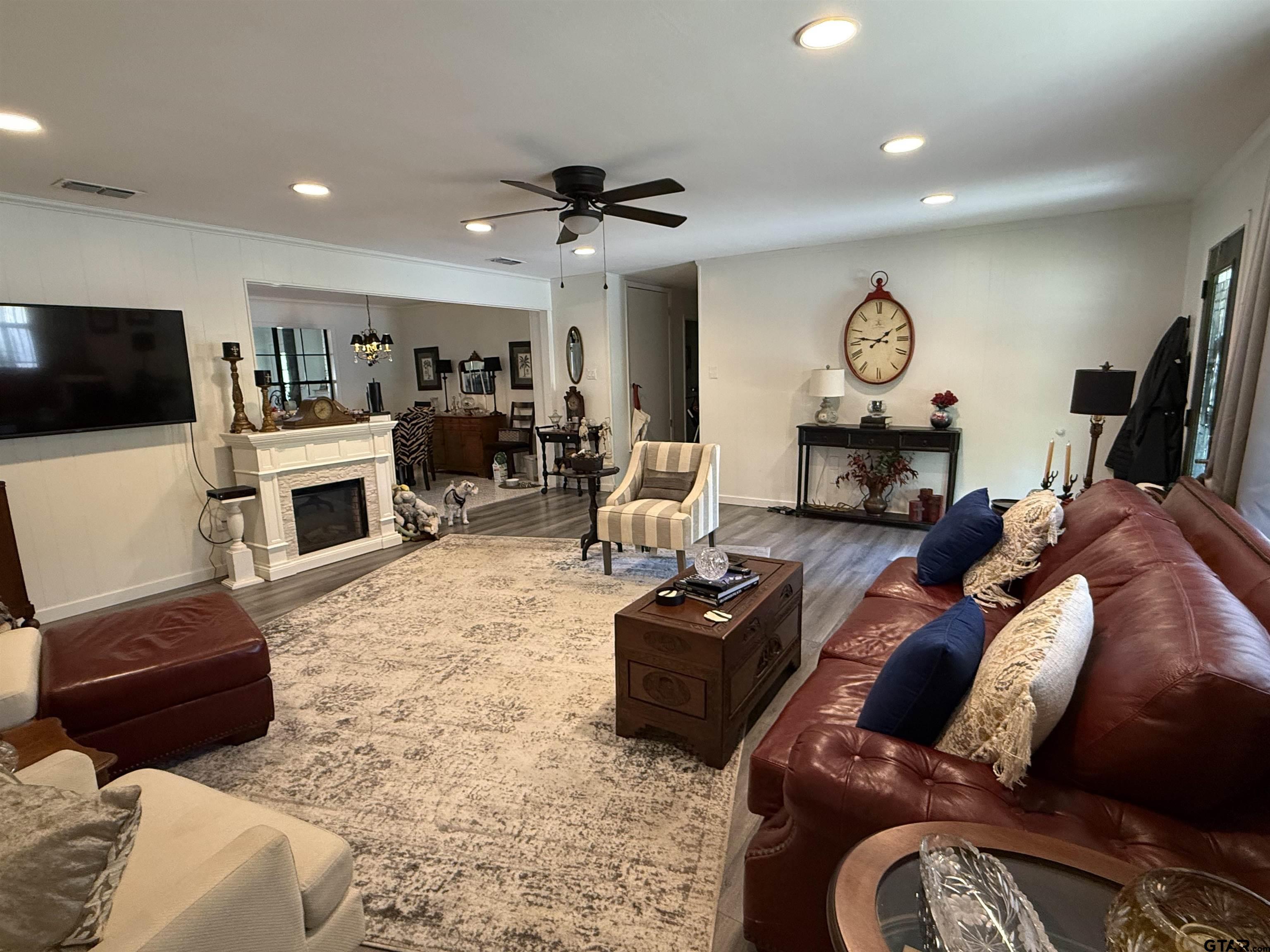608 Pine Street Henderson, TX 75654 - Photo 4 of 46 a living room with furniture a flat screen tv and a fireplace