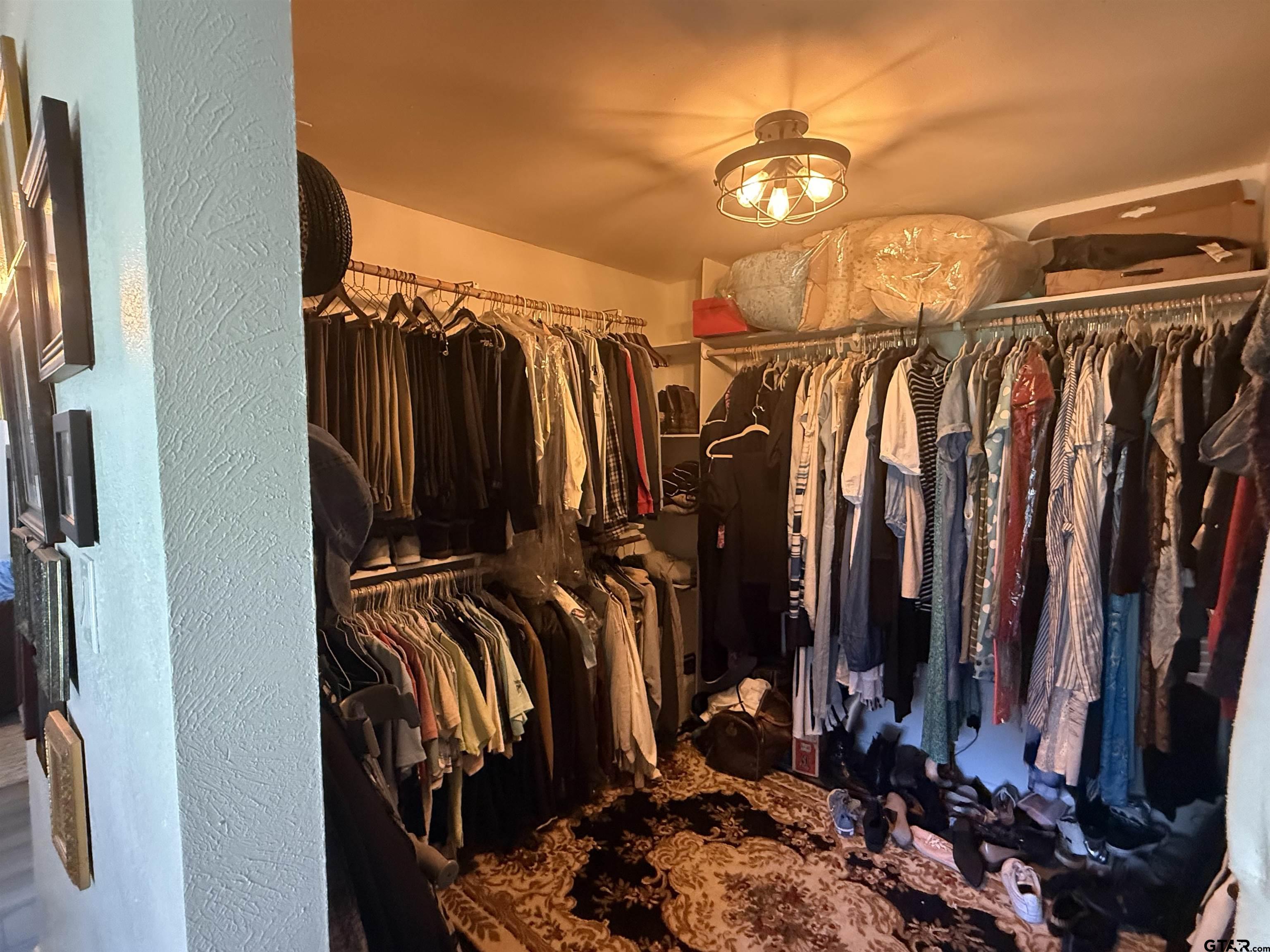 608 Pine Street Henderson, TX 75654 - Photo 42 of 46 a view of walk in closet with clothes and shoes