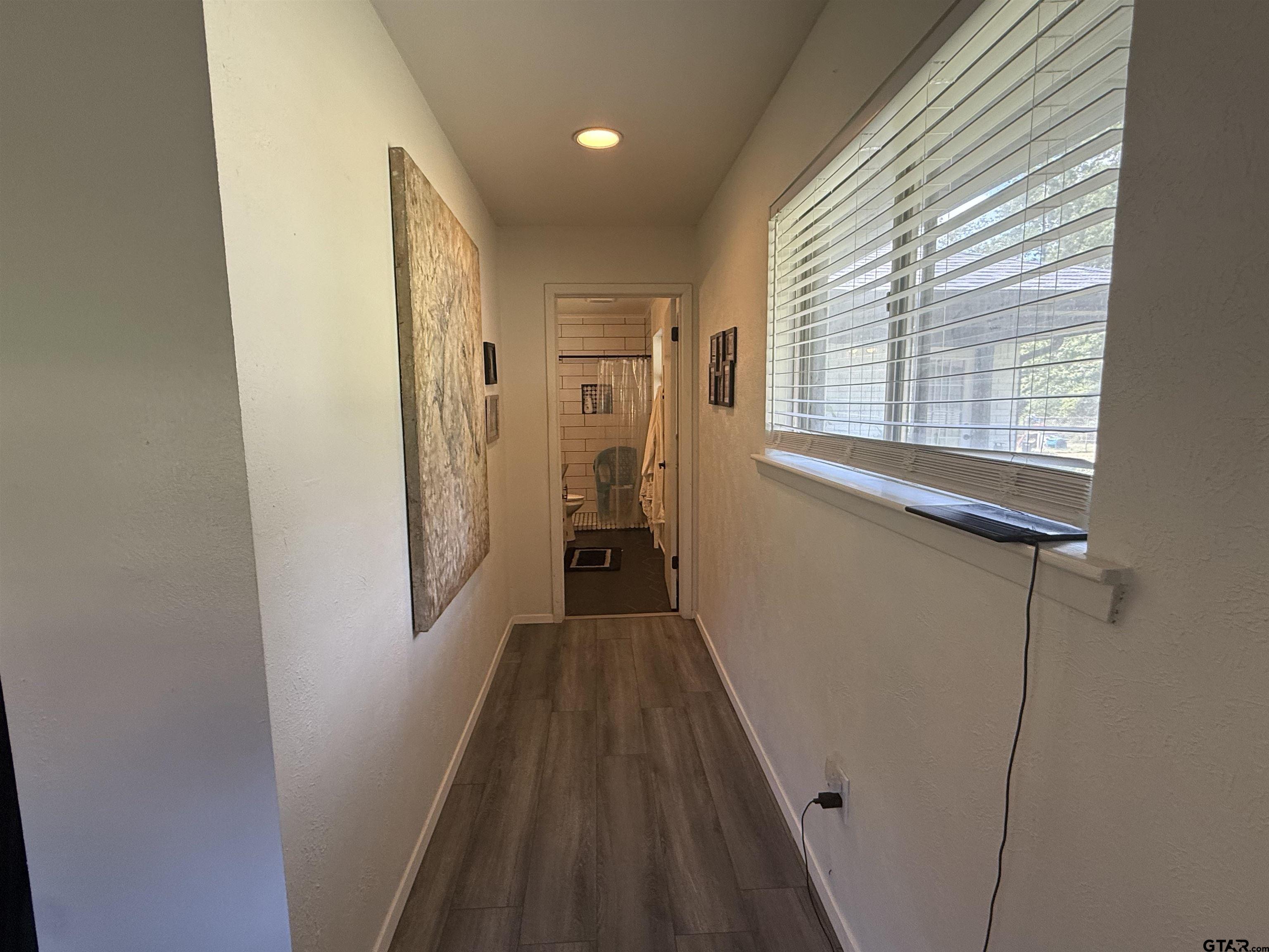 608 Pine Street Henderson, TX 75654 - Photo 43 of 46 a view of a hallway with wooden floor and a window