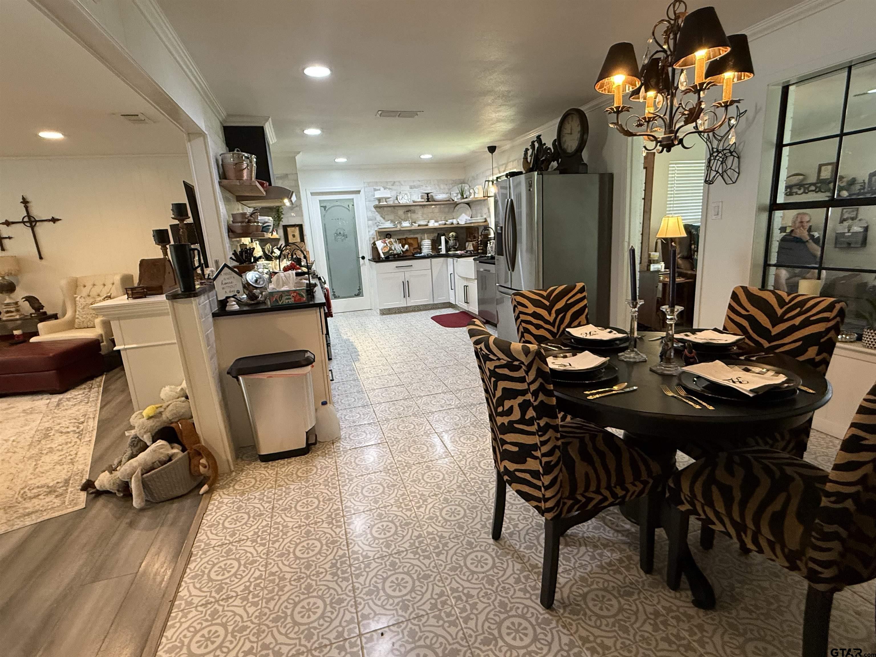 608 Pine Street Henderson, TX 75654 - Photo 6 of 46 a view of a dining room and livingroom with furniture a rug a painting and a chandelier