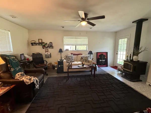 a living room with furniture wooden floor and a window