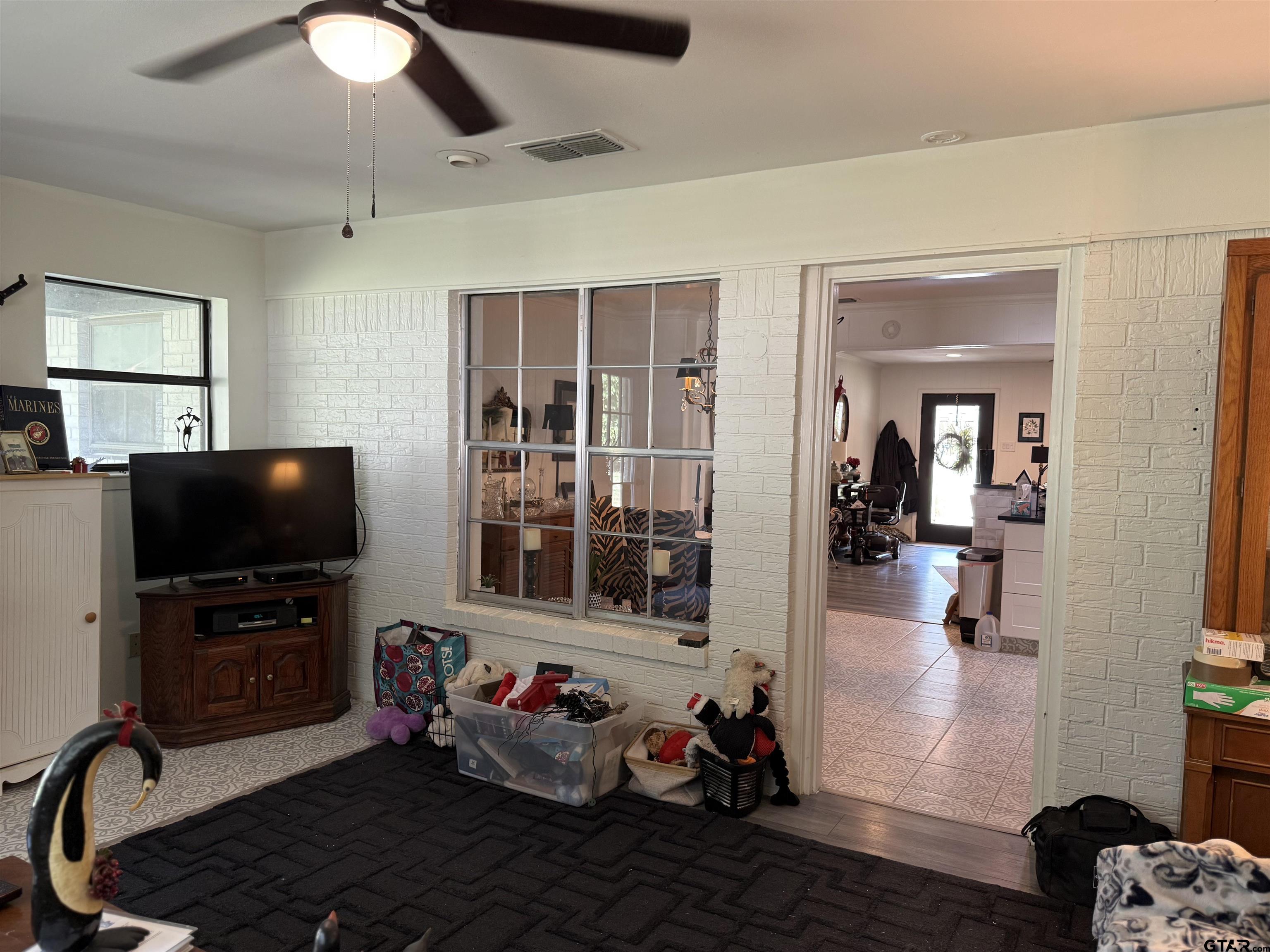 608 Pine Street Henderson, TX 75654 - Photo 10 of 46 a living room with furniture and a flat screen tv