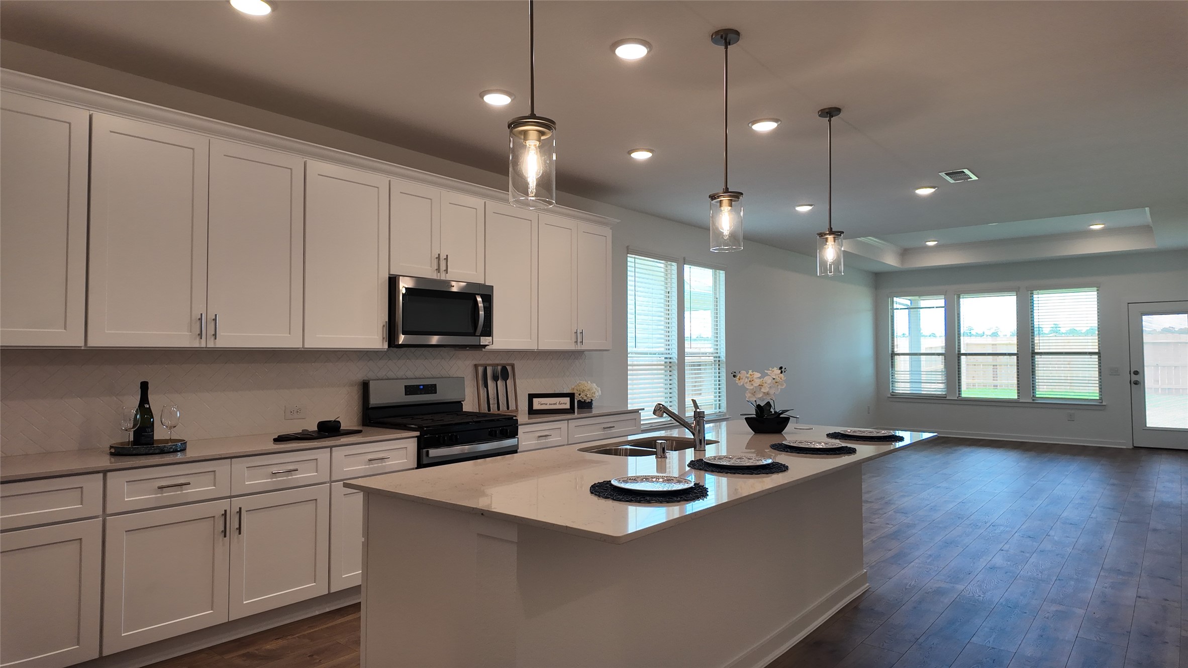 15645 Wandering Maple Way Conroe, TX 77302 - Photo 4 of 14 a kitchen with sink stove and cabinets