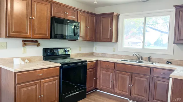 a kitchen with a sink cabinets and window