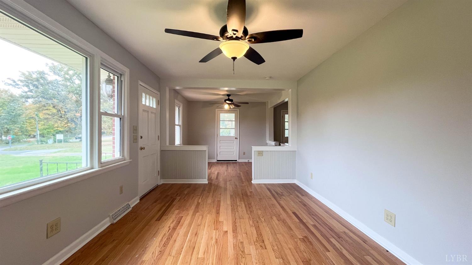751 Long Island Road Gladys, VA 24554 - Photo 28 of 63 a view of a room with wooden floor a ceiling fan and windows