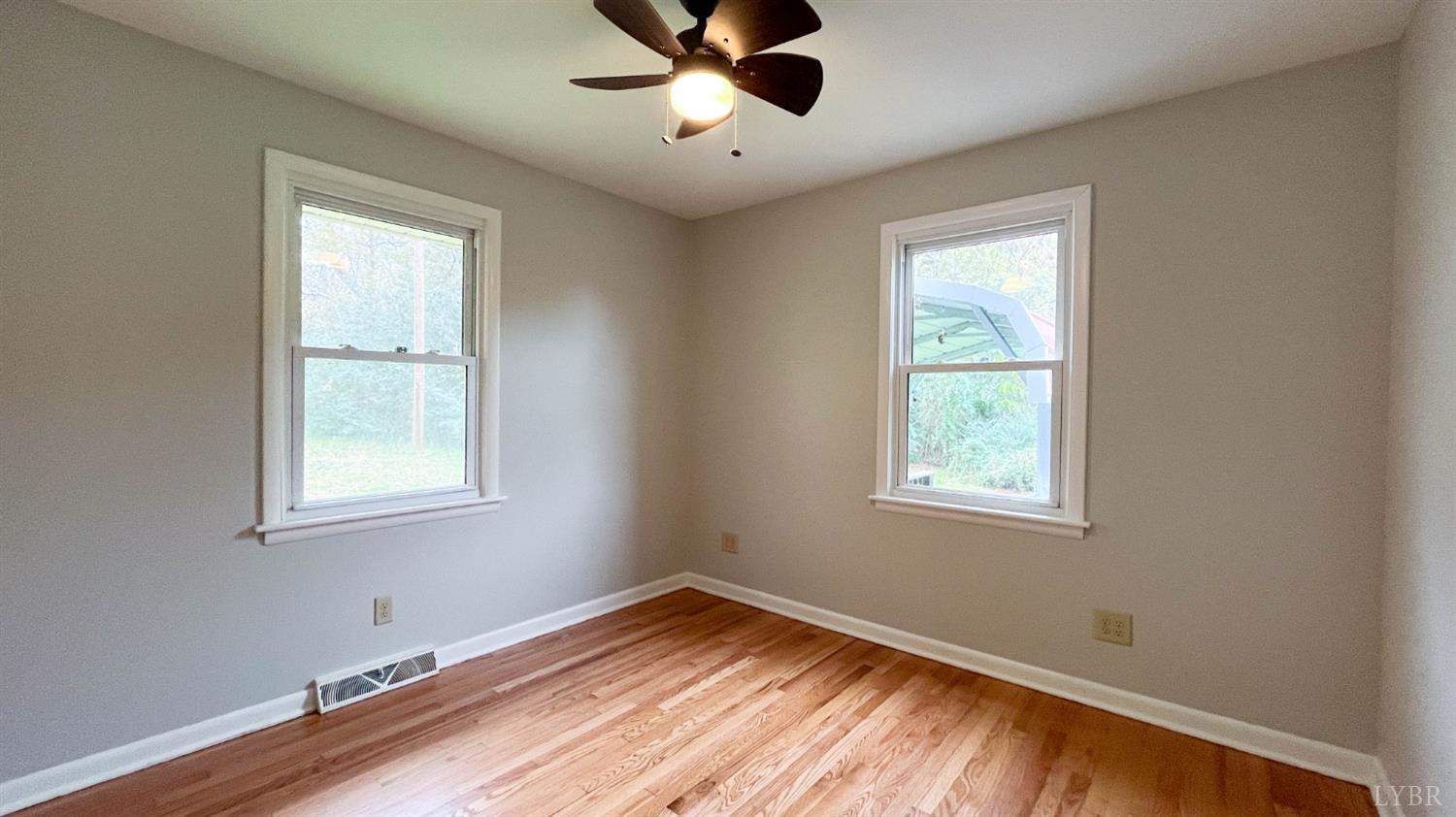 751 Long Island Road Gladys, VA 24554 - Photo 34 of 63 a view of an empty room with wooden floor and a window