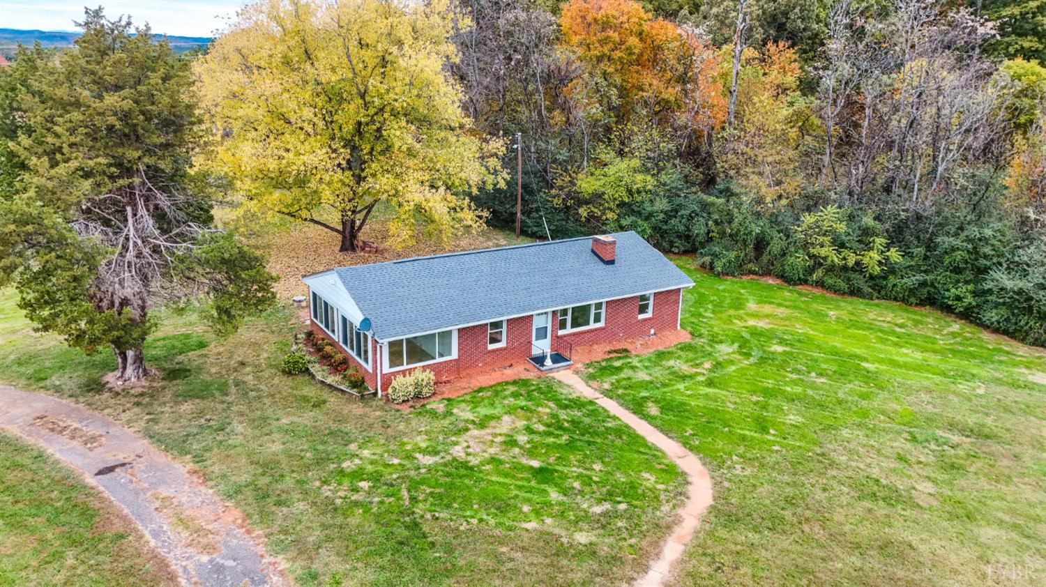 751 Long Island Road Gladys, VA 24554 - Photo 4 of 63 a aerial view of a house with yard and trees in the background