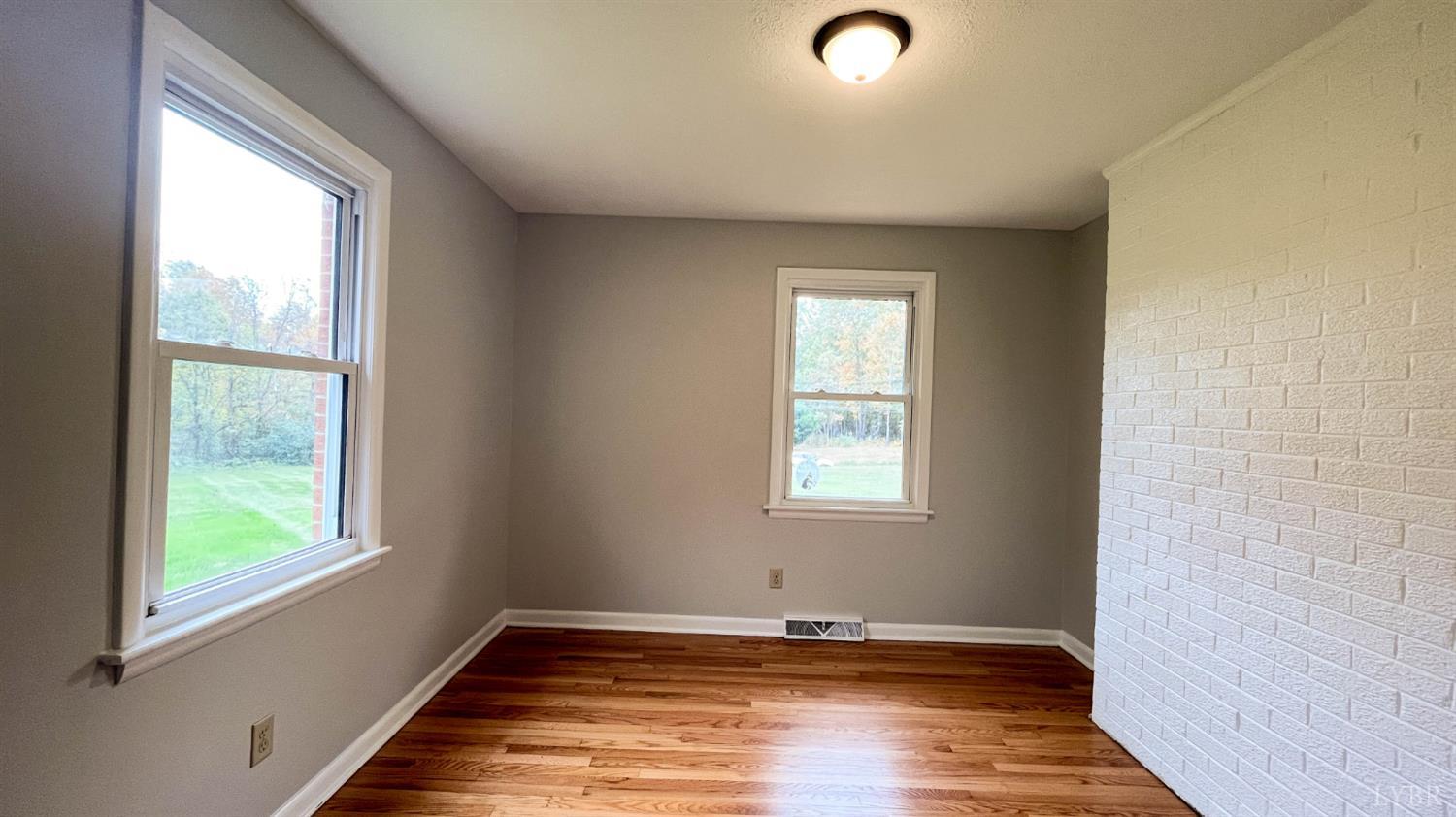 751 Long Island Road Gladys, VA 24554 - Photo 42 of 63 a view of an empty room with wooden floor and a window