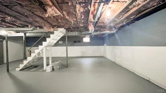 a front view of a house with swimming pool and trees