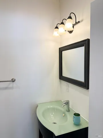 a bathroom with a sink and mirror