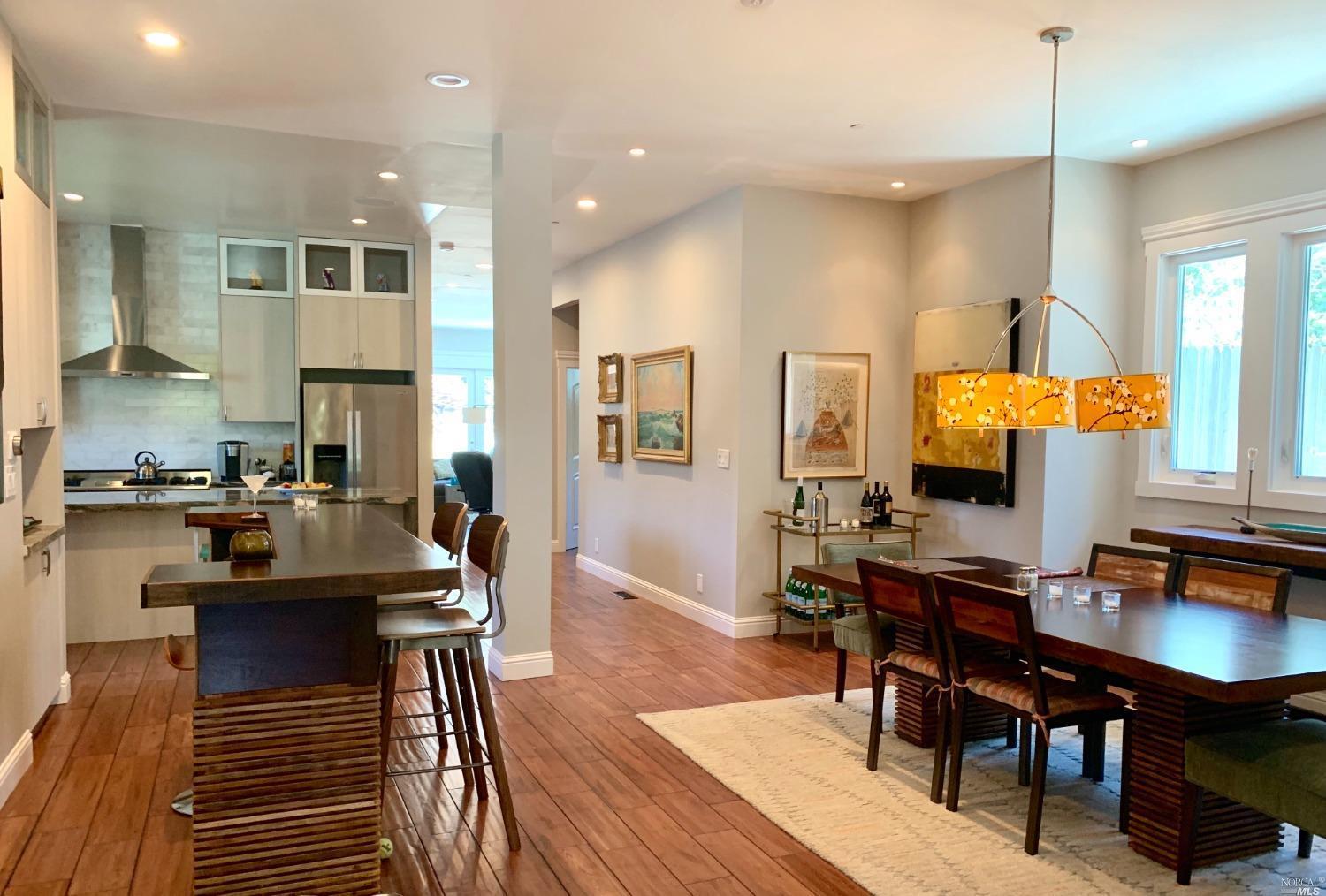 40 Villa Avenue San Rafael, CA 94901 - Photo 40 of 48 a kitchen with stainless steel appliances kitchen island granite countertop a stove a sink a dining table and chairs with wooden floor