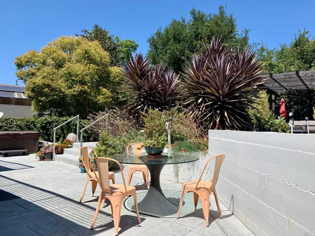a view of a chairs and table in patio