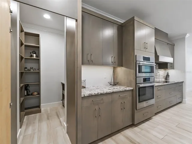 a kitchen with stainless steel appliances granite countertop a refrigerator and a sink
