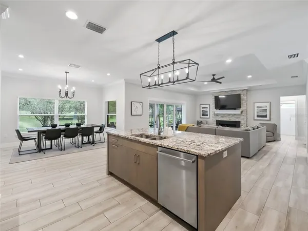 a kitchen with stainless steel appliances kitchen island granite countertop a kitchen island a stove and a refrigerator