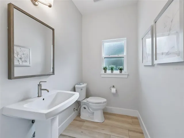 a spacious bedroom with a bed and a chandelier