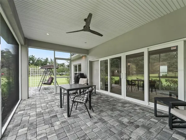 a front view of a house with a garden and lake view