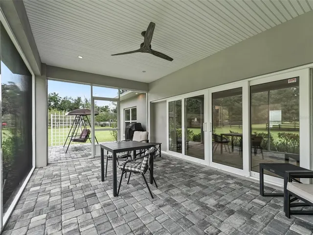 a front view of a house with a garden and lake view