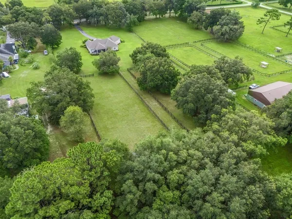 an aerial view of a houses with yard