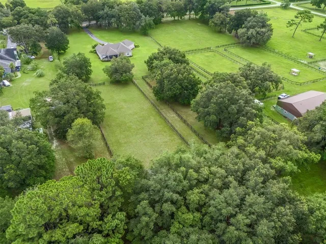 an aerial view of a houses with yard