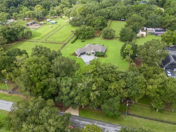 an aerial view of a houses with outdoor space and a lake view