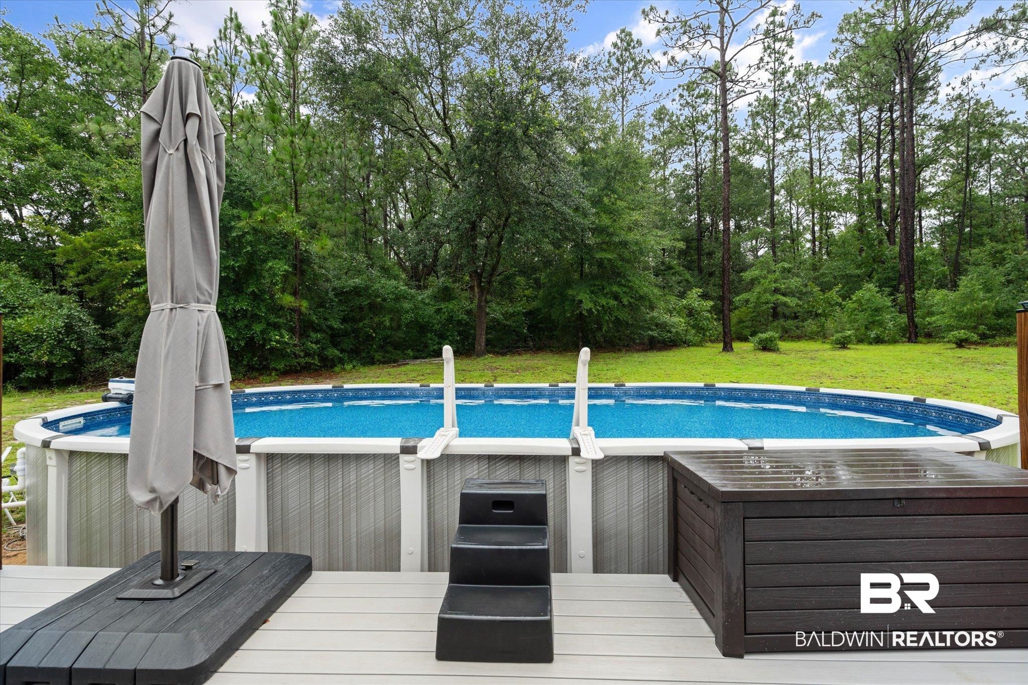 2300 Radcliff Road Saraland, AL 36571 - Photo 37 of 56 Swimming pool with a lawn and a wooden deck