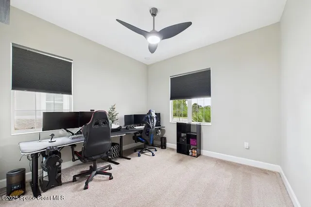 a view of a livingroom with workspace and a window