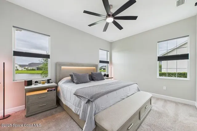 a bedroom with a large bed and a window