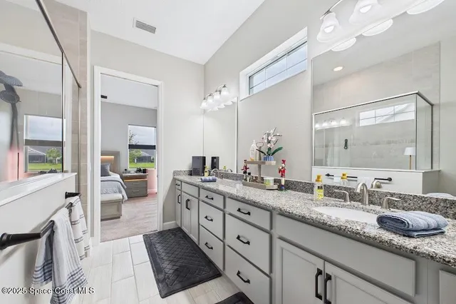 a spacious bathroom with a granite countertop sink mirror and a