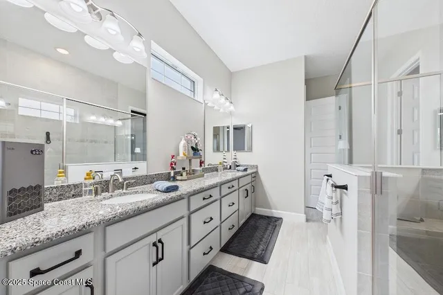 a spacious bathroom with a double vanity sink mirror and double