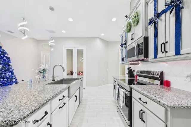 a bathroom with a granite countertop double vanity sink and a mirror